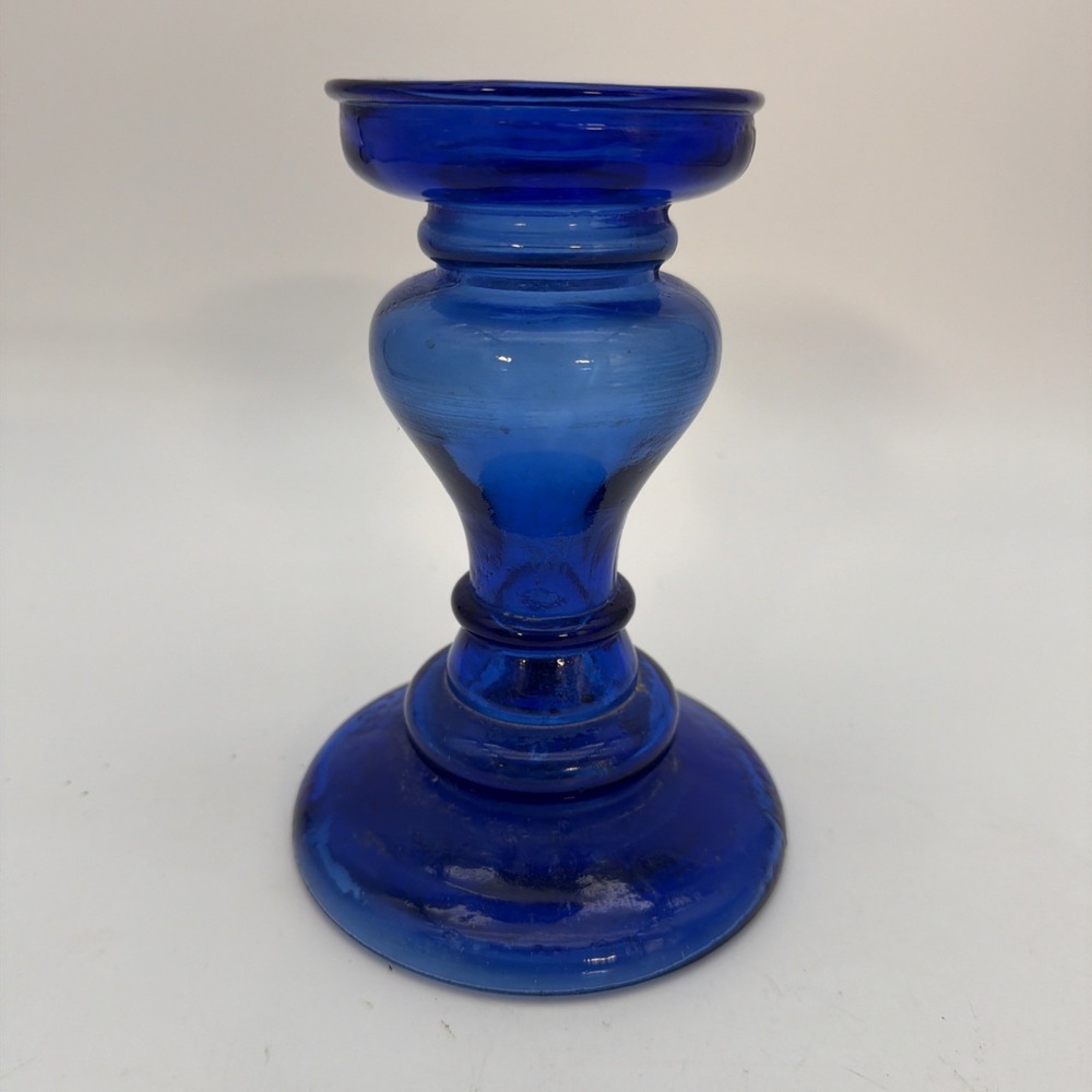 vibrant cobalt blue glass candle holder with a bulbous mid-section